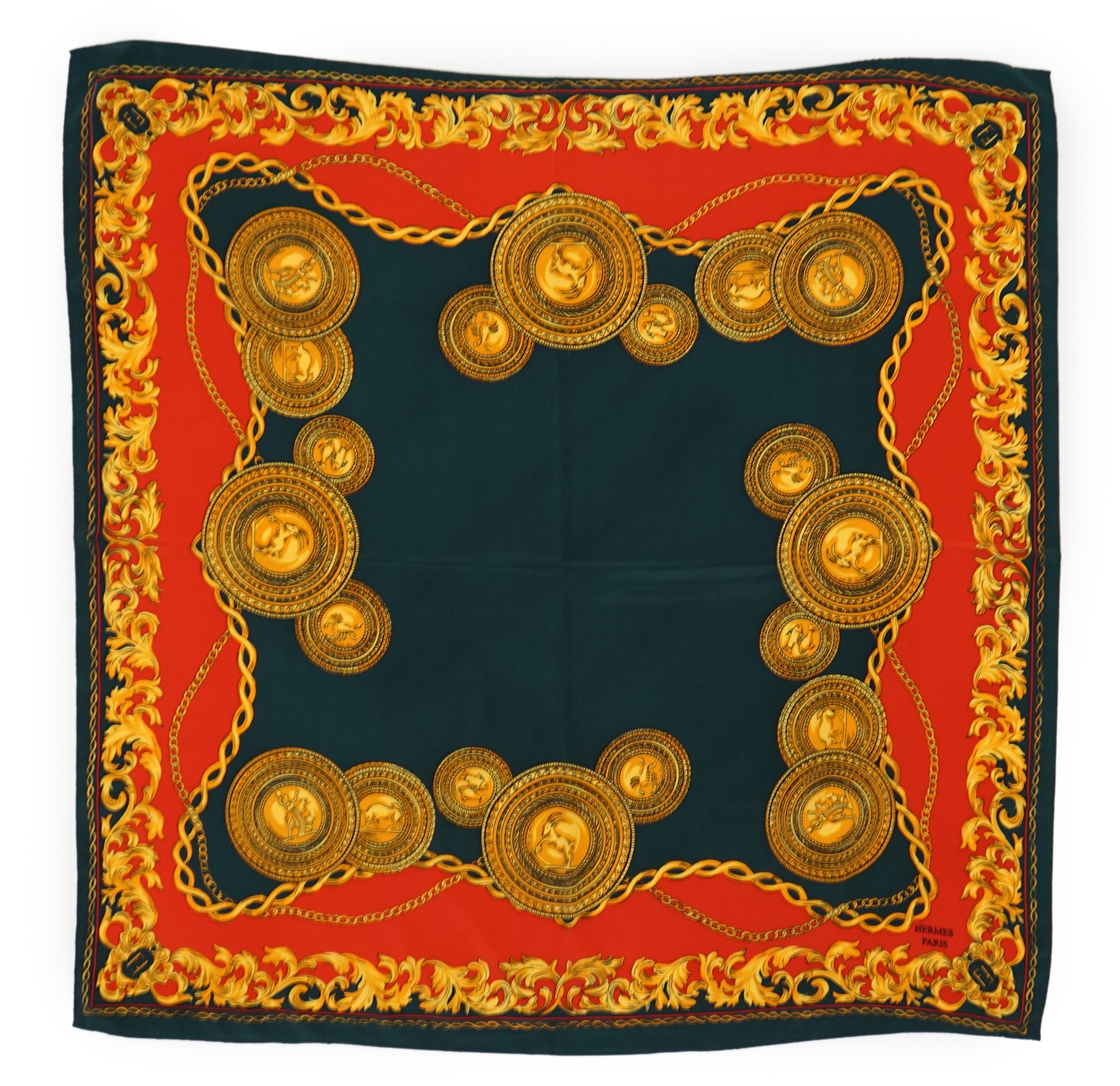 A Hermès silk scarf decorated with gold zodiac sign animals and hybrids, gold foliage and chain design around the edges, 90 x 84cm